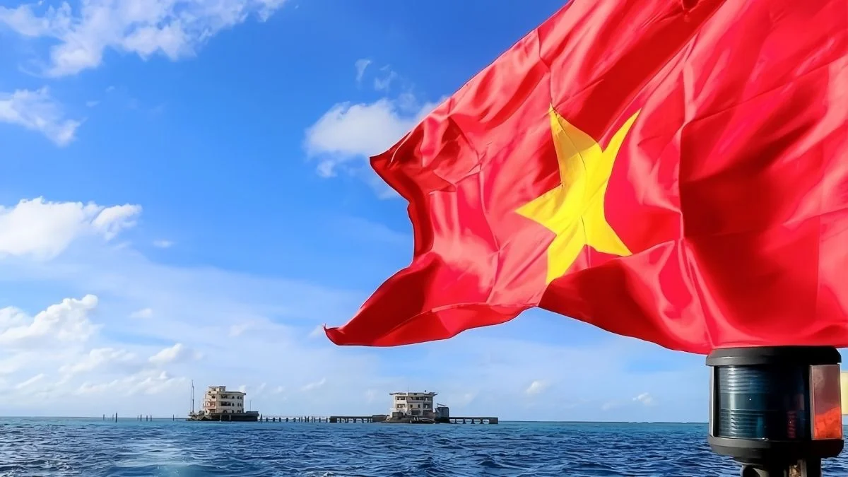 Ảnh lá cờ Việt Nam đỏ sao vàng tung bay trên biển xanh dưới bầu trời trong xanh